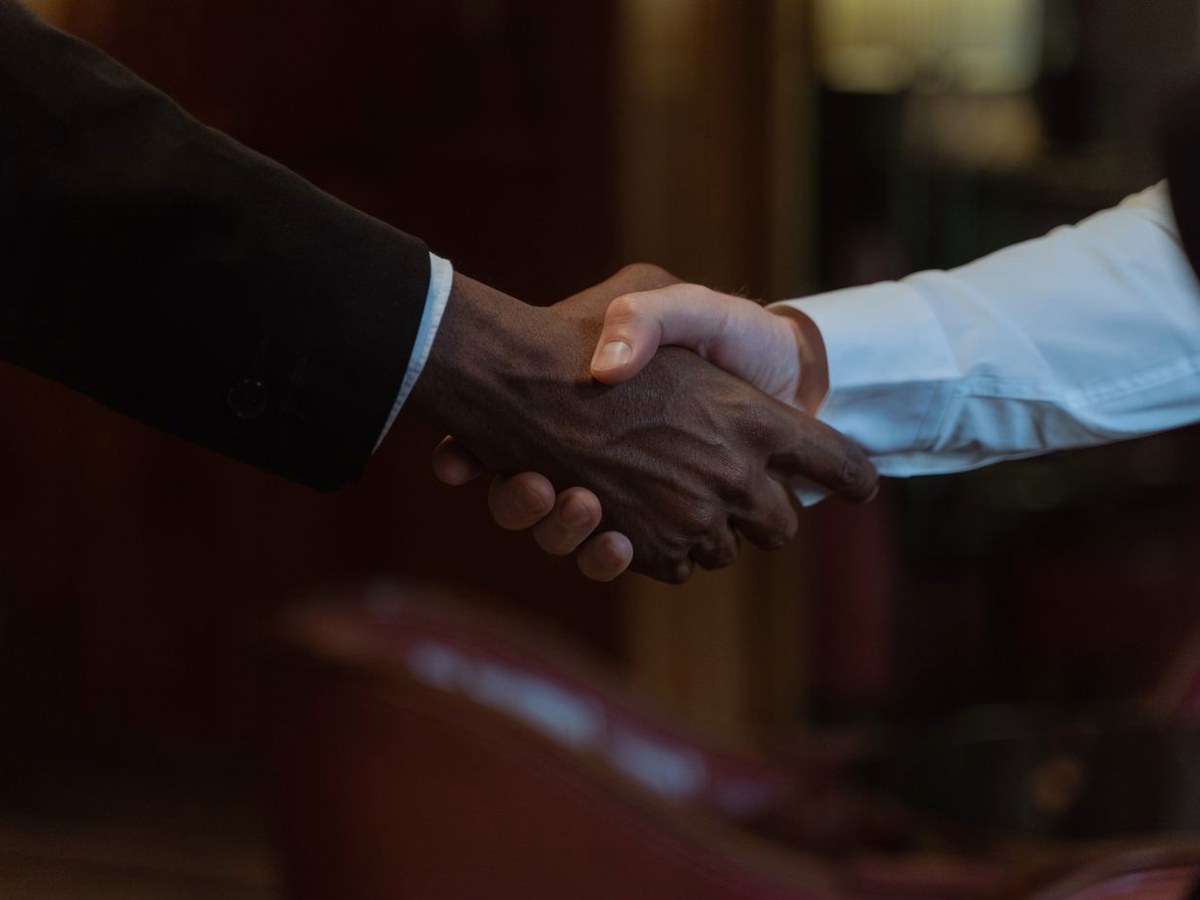 Two business owners shaking hands on a deal