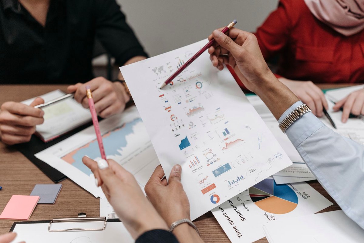 Business team closing a deal around a table